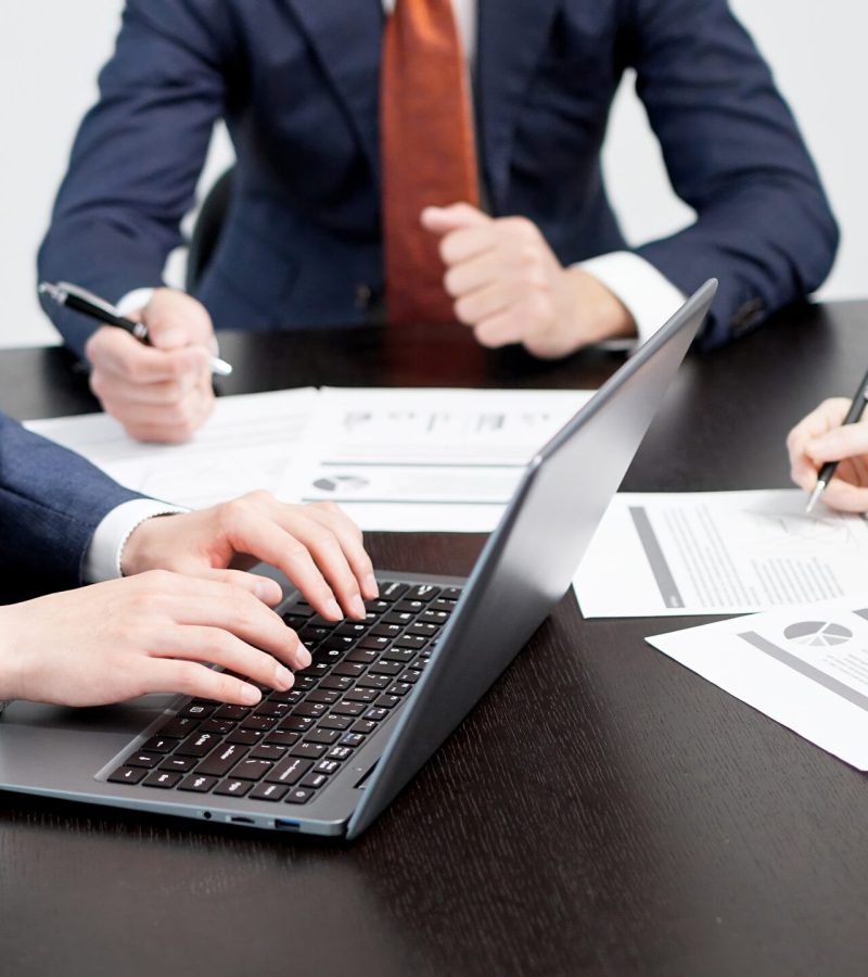Business people typing in a meeting